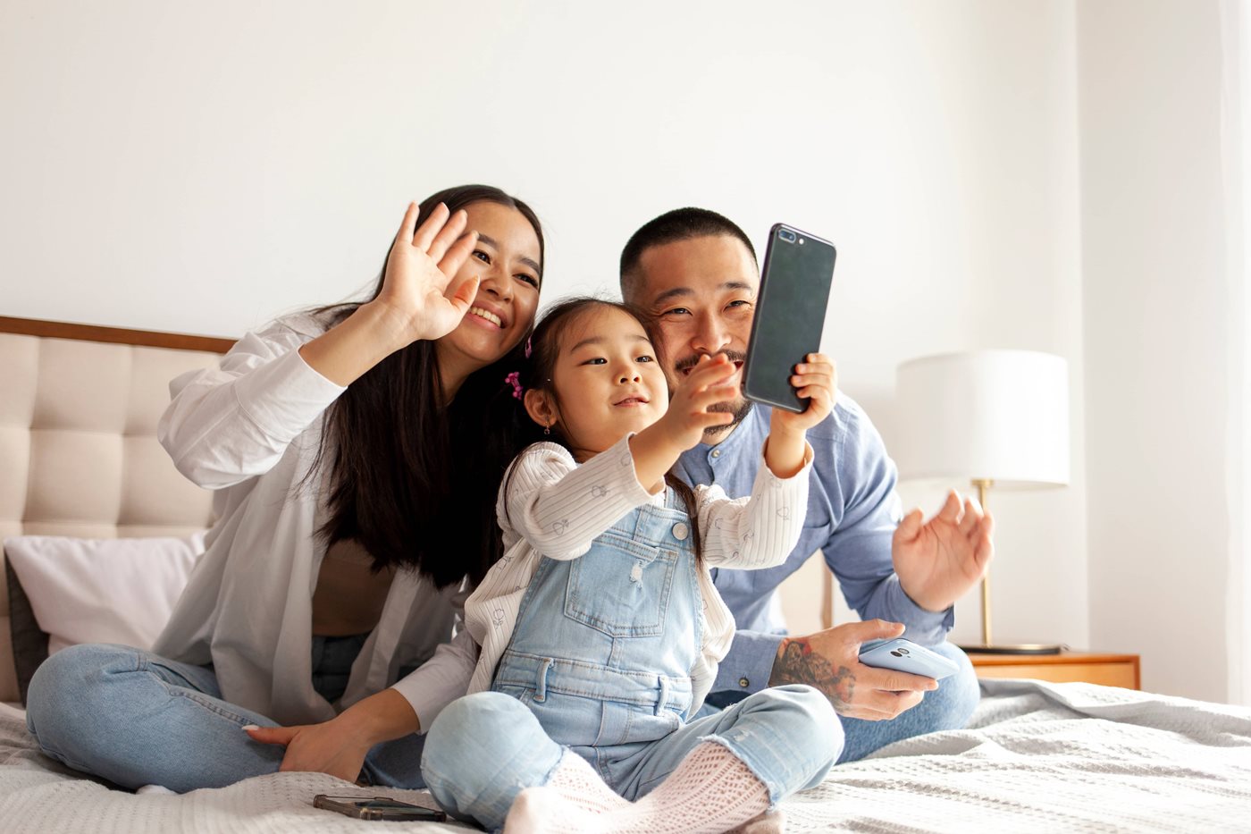 A military family made up of two parents and their young daughter FaceTime family with a SmartPhone after their PCS move