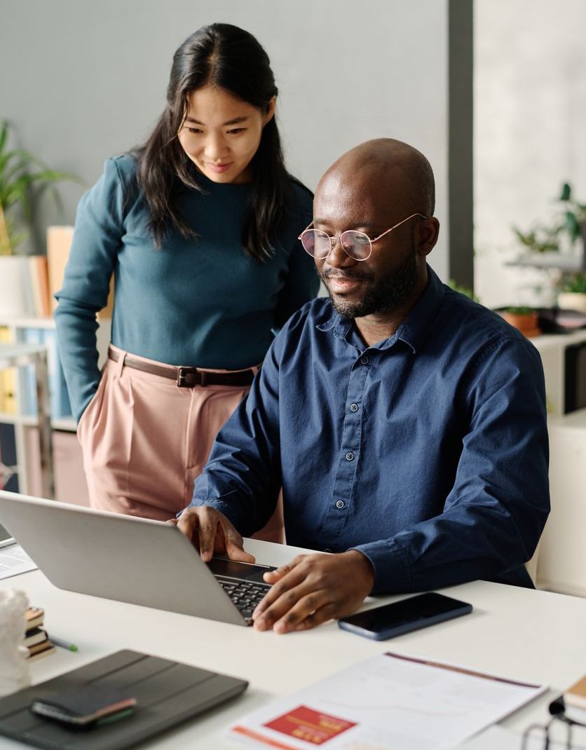 Black Man And Asian Woman Working On Plan