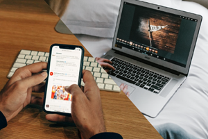 Person reviewing phone and laptop