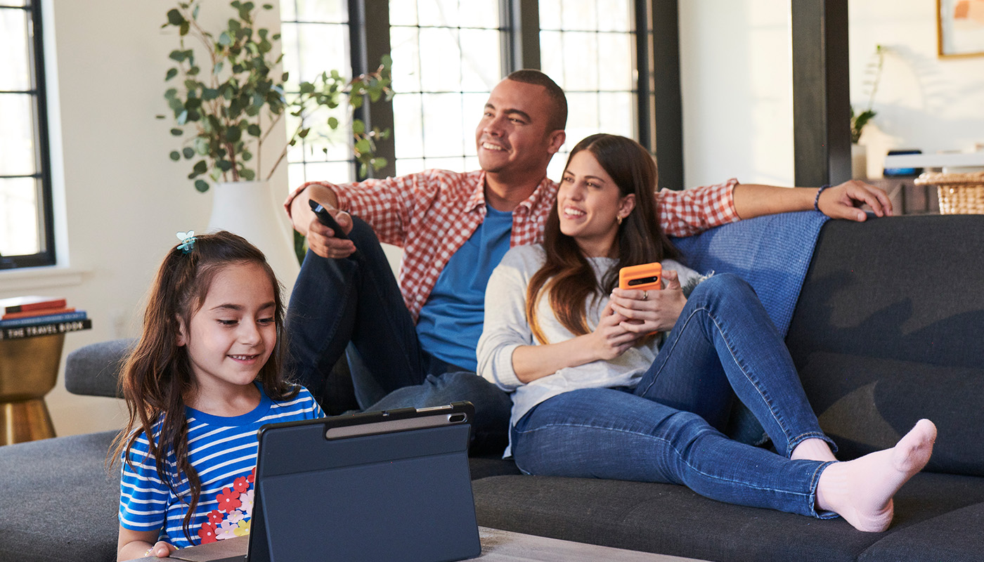 A family hangs out in their living room while enjoying Optimum Internet and Cable services