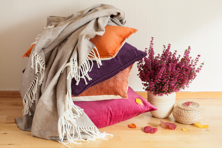 Layering throw pillows and blankets add texture to your home