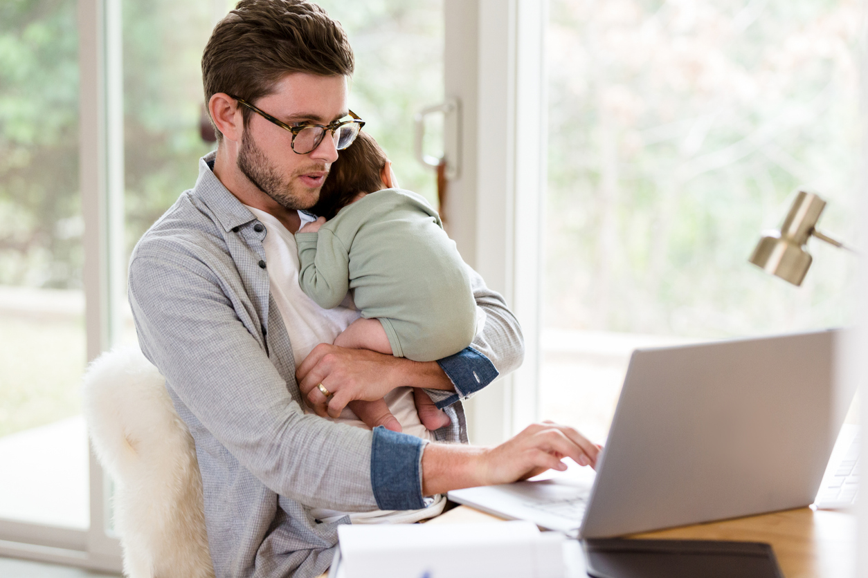 A military service member caring for baby while searching for military streaming discounts