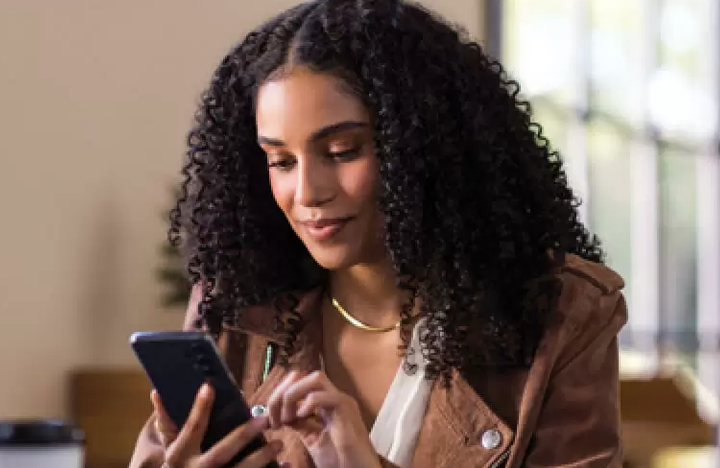 A young professional women looks at her mobile device