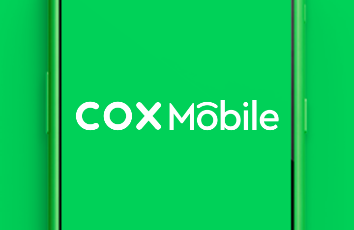 Green phone screen displaying the words Cox Mobile
