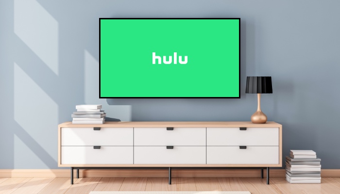 A TV with Hulu on the screen sits above a white TV stand